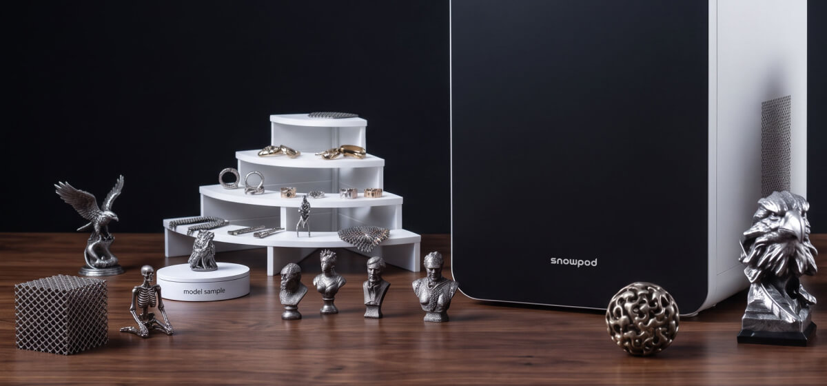 Metal miniatures printed on SnowPod beside the desktop printer